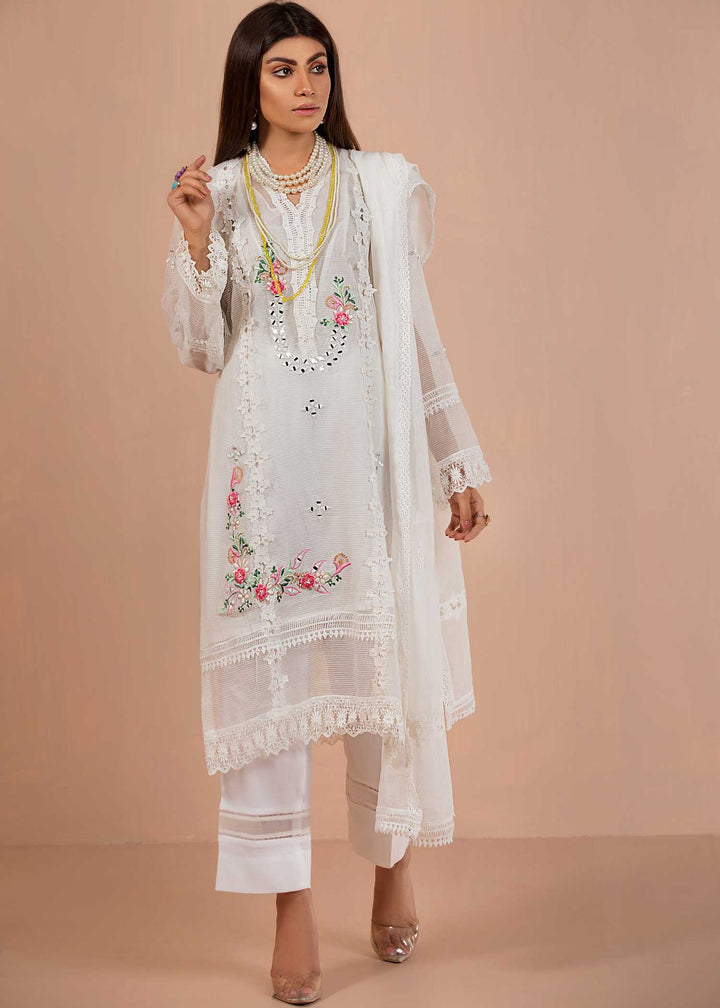 model wearing embroidered white suit with floral details -1