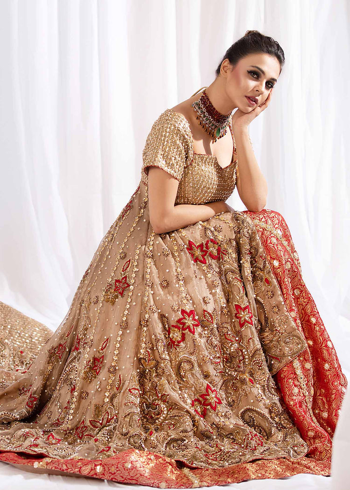 Model wearing Gold Embellished Tail Frock with Red Lehenga -3